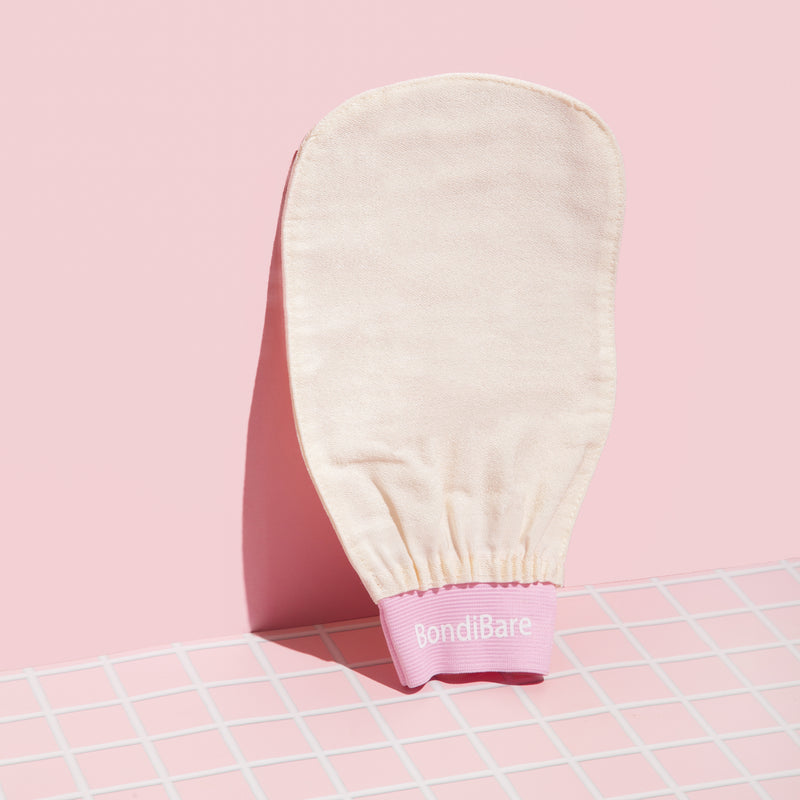 BondiBare exfoliating glove against a pink wall